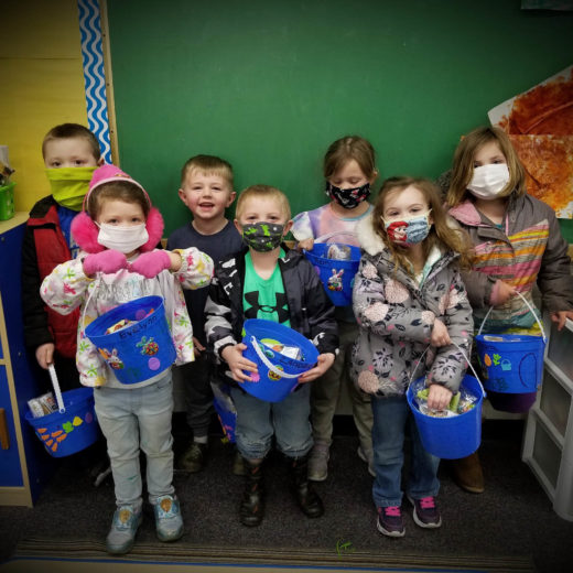 A group of children with masks on.