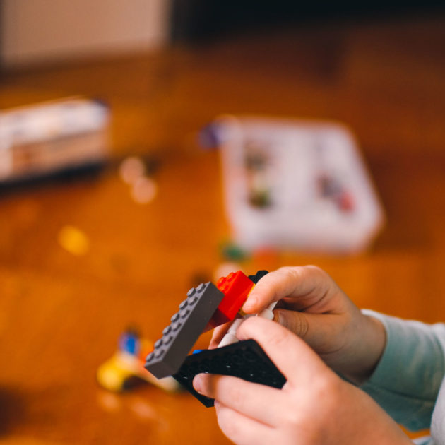 A boy playing with a lego set.