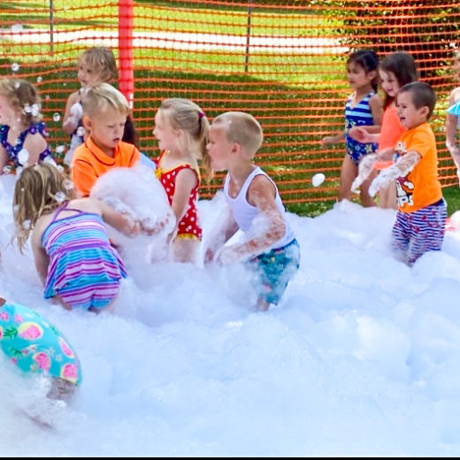 Children playing in a pool of bubbles.