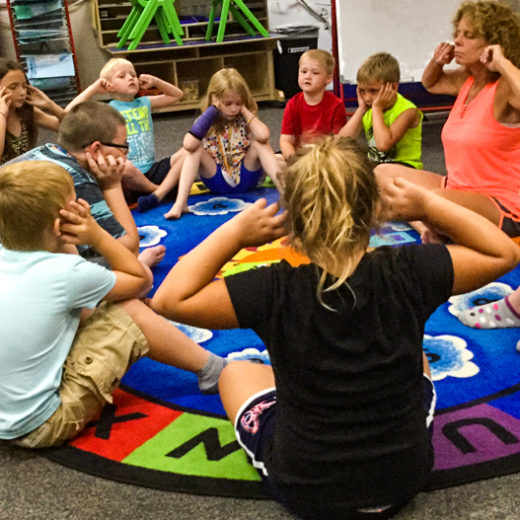 Children playing together on a mat.