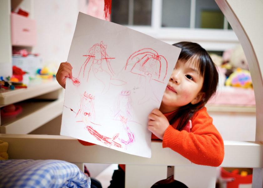 A child showing off her drawing.