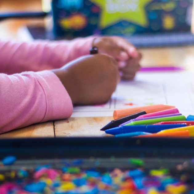 A child playing with crayons.