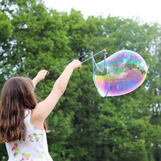 Girl making bubbles.