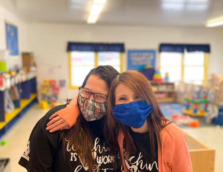 Two girls wearing masks.