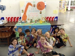 A group of children posing for a picture in a classroom.