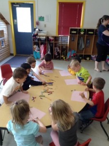 A group of children sitting around a table.