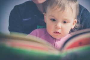 parent reading with baby