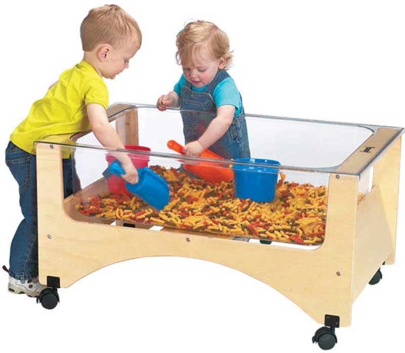 Two children playing with a sand table.