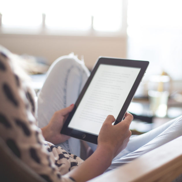 A young woman on an ipad.